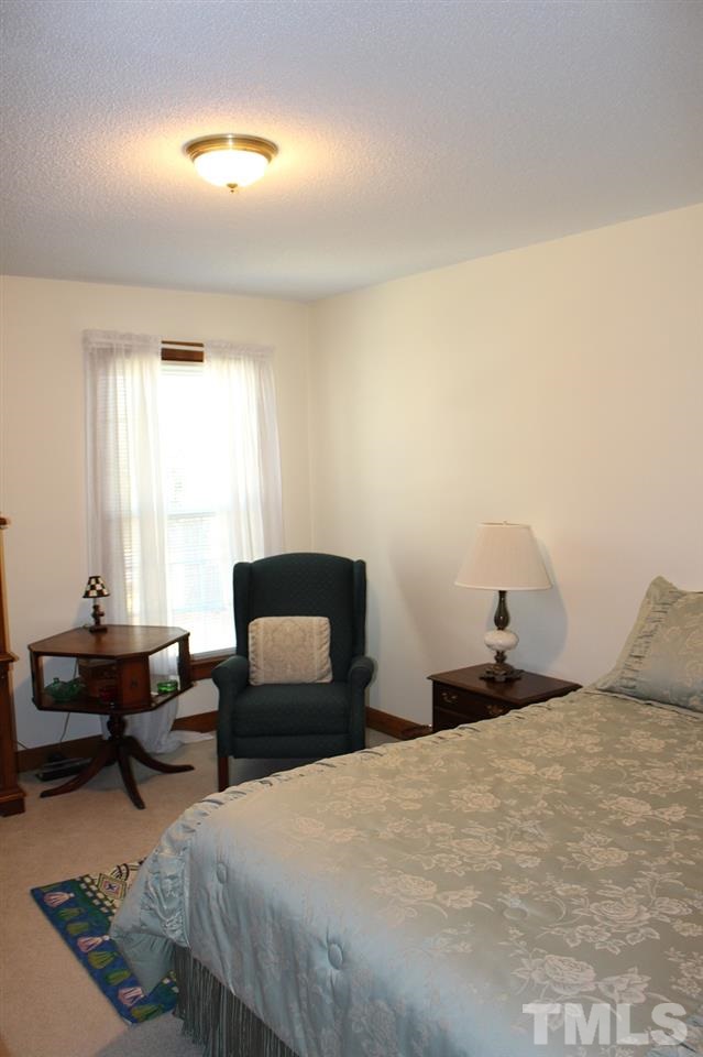 8709 Campfire Trail Raleigh, NC 27615 - Photo 12 of 25 a bedroom with a bed and a window
