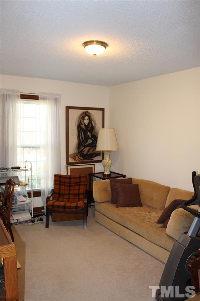 8709 Campfire Trail Raleigh, NC 27615 - Photo 13 of 25 a living room with furniture and a window