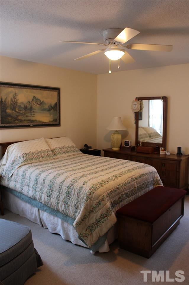 8709 Campfire Trail Raleigh, NC 27615 - Photo 14 of 25 a bedroom with a bed and mirror