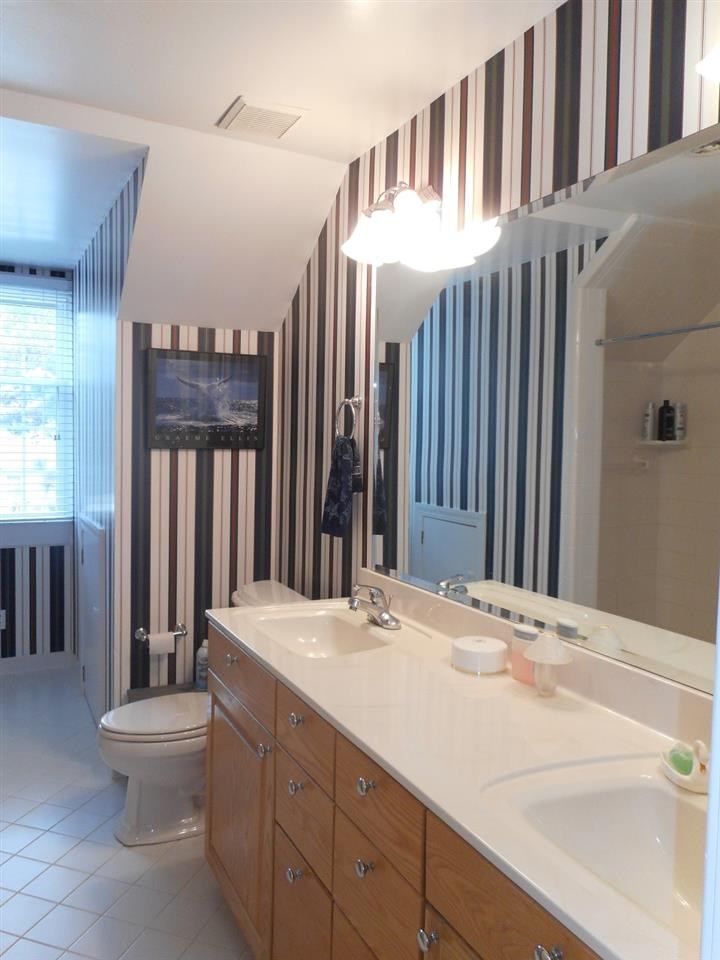 8709 Campfire Trail Raleigh, NC 27615 - Photo 17 of 25 a bathroom with a sink and a toilet