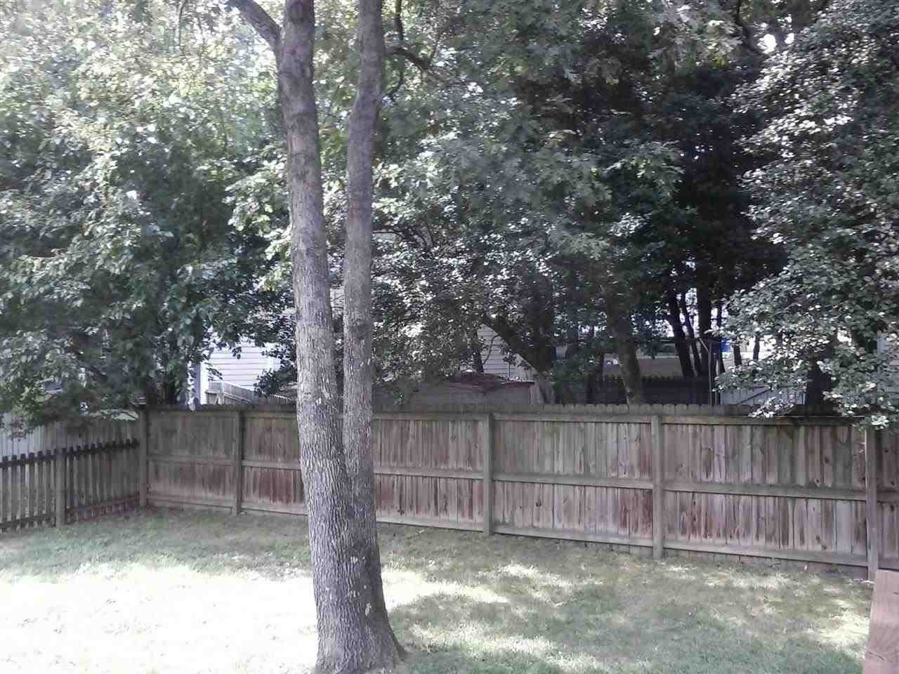 8709 Campfire Trail Raleigh, NC 27615 - Photo 21 of 25 a view of backyard with tree and wooden fence