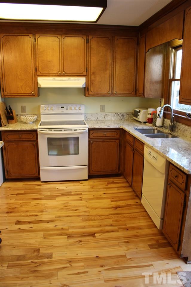 8709 Campfire Trail Raleigh, NC 27615 - Photo 4 of 25 a kitchen with stainless steel appliances granite countertop a sink stove and cabinets