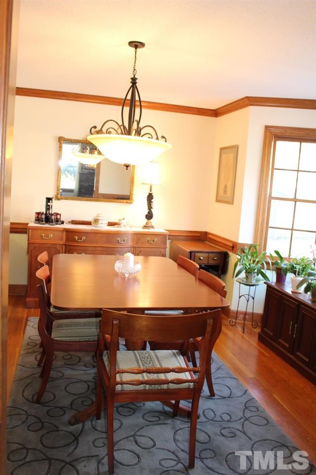 8709 Campfire Trail Raleigh, NC 27615 - Photo 8 of 25 a room with a table chairs and a view of living room