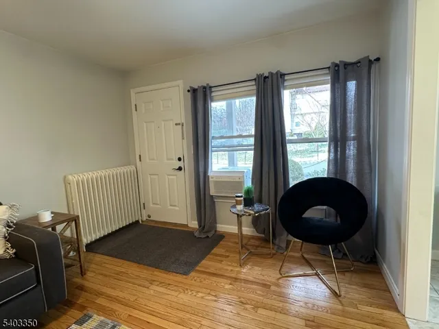 a living room with furniture and a chair