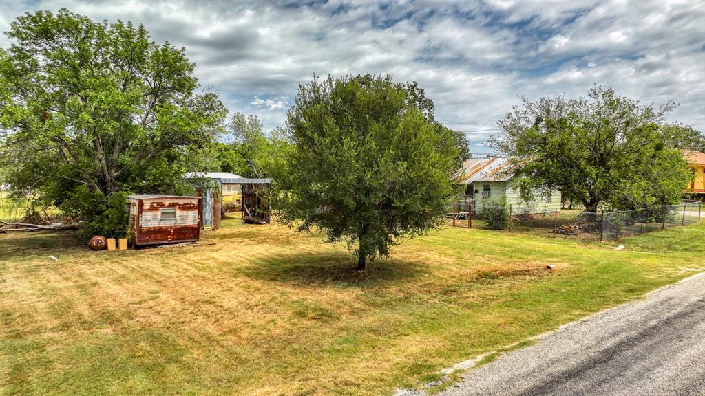 62 Travis Street Santo, TX 76472 - Photo 2 of 9 a swimming pool with trees in the background