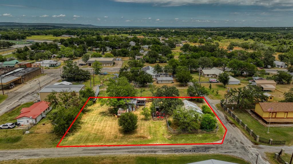 62 Travis Street Santo, TX 76472 - Photo 4 of 9 an aerial view of residential houses with outdoor space