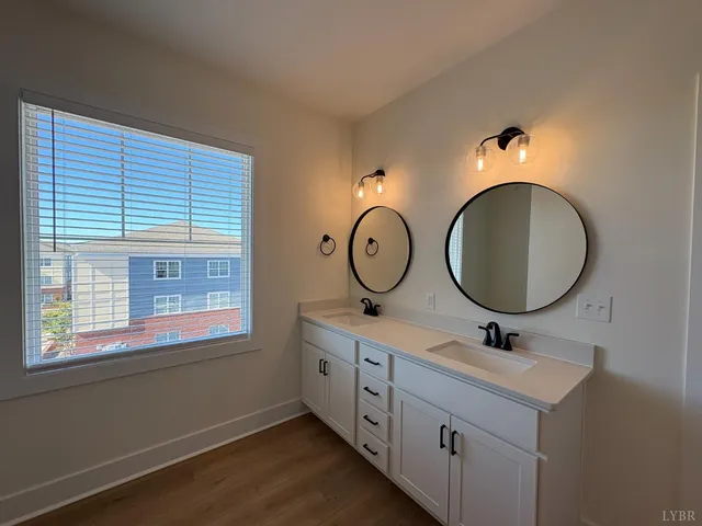 a bathroom with 2 sink and a mirror