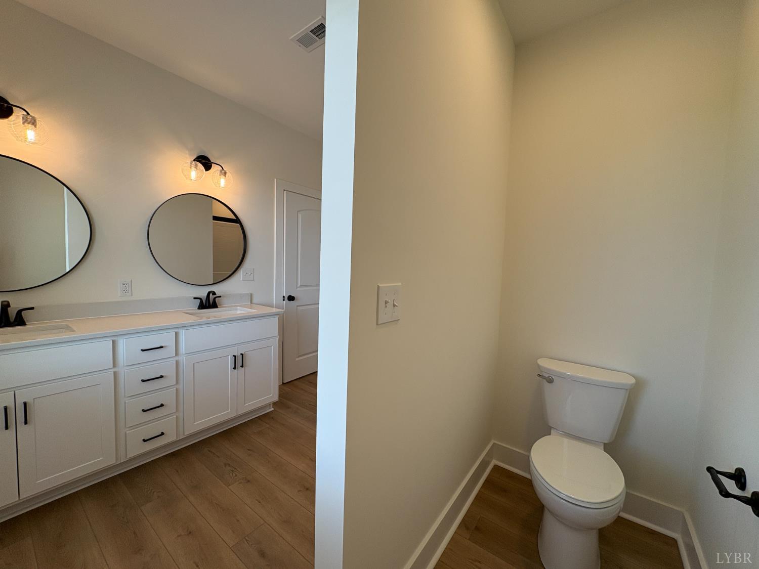 420 Capstone Drive, Unit 306 Lynchburg, VA 24502 - Photo 16 of 37 a bathroom with a toilet a sink and mirror