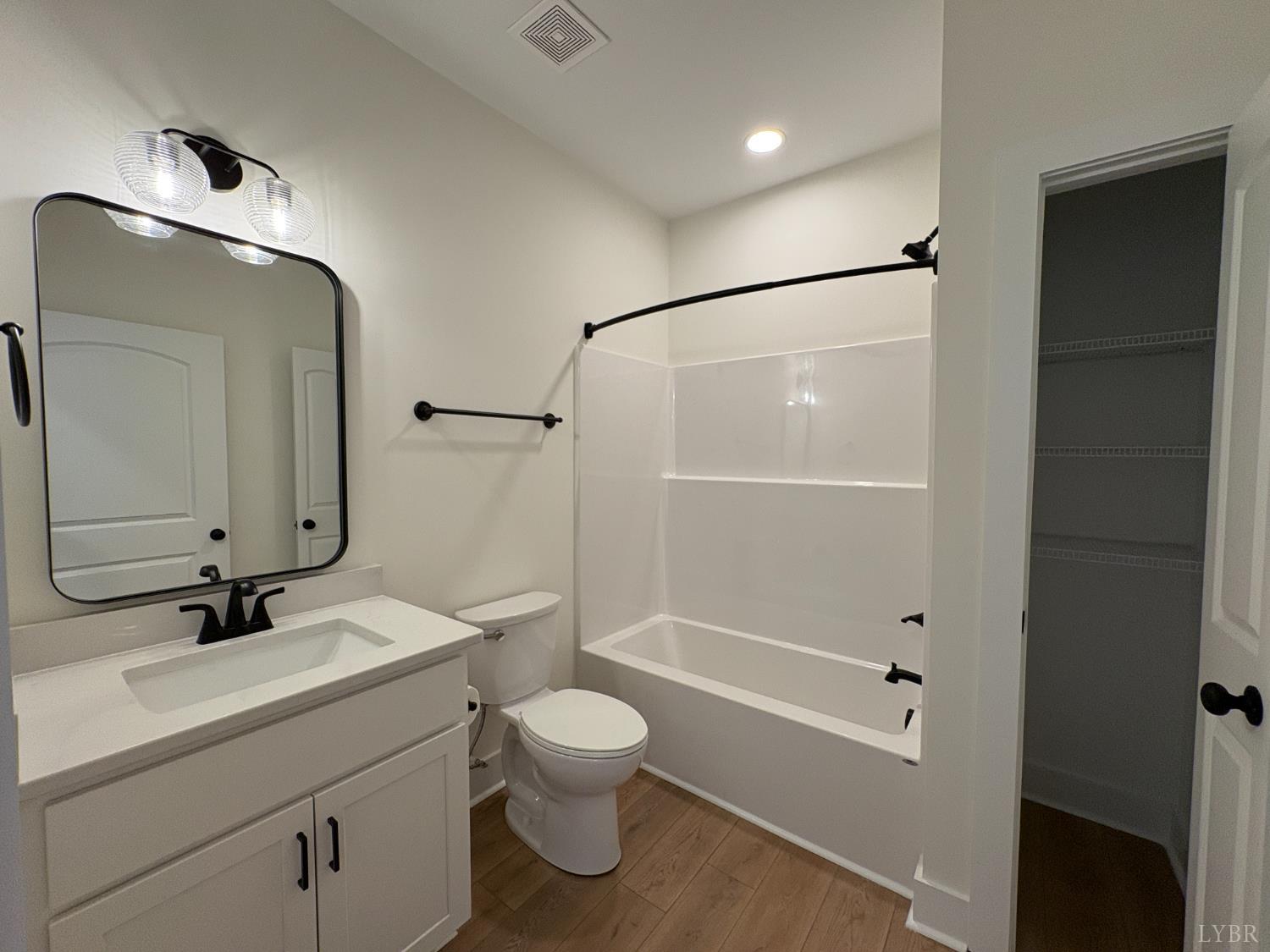 420 Capstone Drive, Unit 306 Lynchburg, VA 24502 - Photo 22 of 37 a bathroom with a bathtub shower sink vanity mirror and toilet