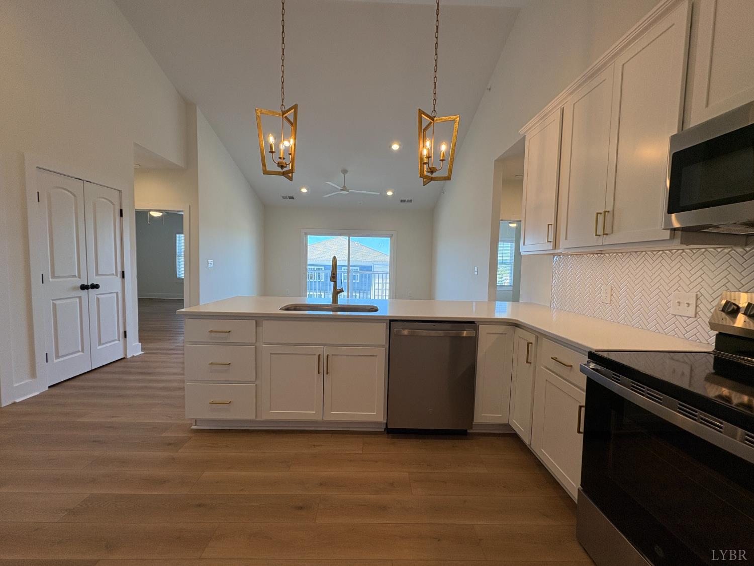 420 Capstone Drive, Unit 306 Lynchburg, VA 24502 - Photo 5 of 37 a large kitchen with cabinets stainless steel appliances a sink and a stove