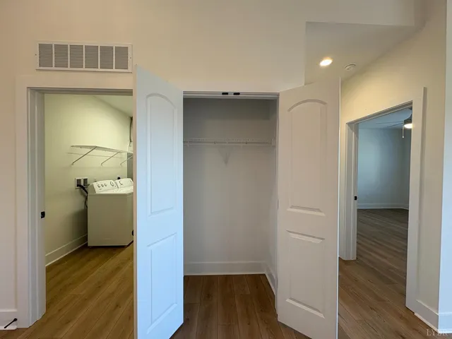 a view of a room with wooden floor and closet