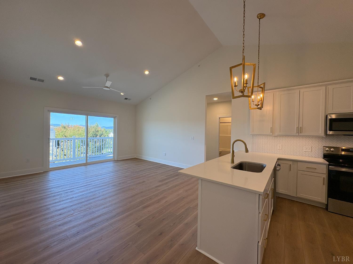 420 Capstone Drive, Unit 306 Lynchburg, VA 24502 - Photo 8 of 37 a kitchen with stainless steel appliances granite countertop a sink a stove and a wooden floors