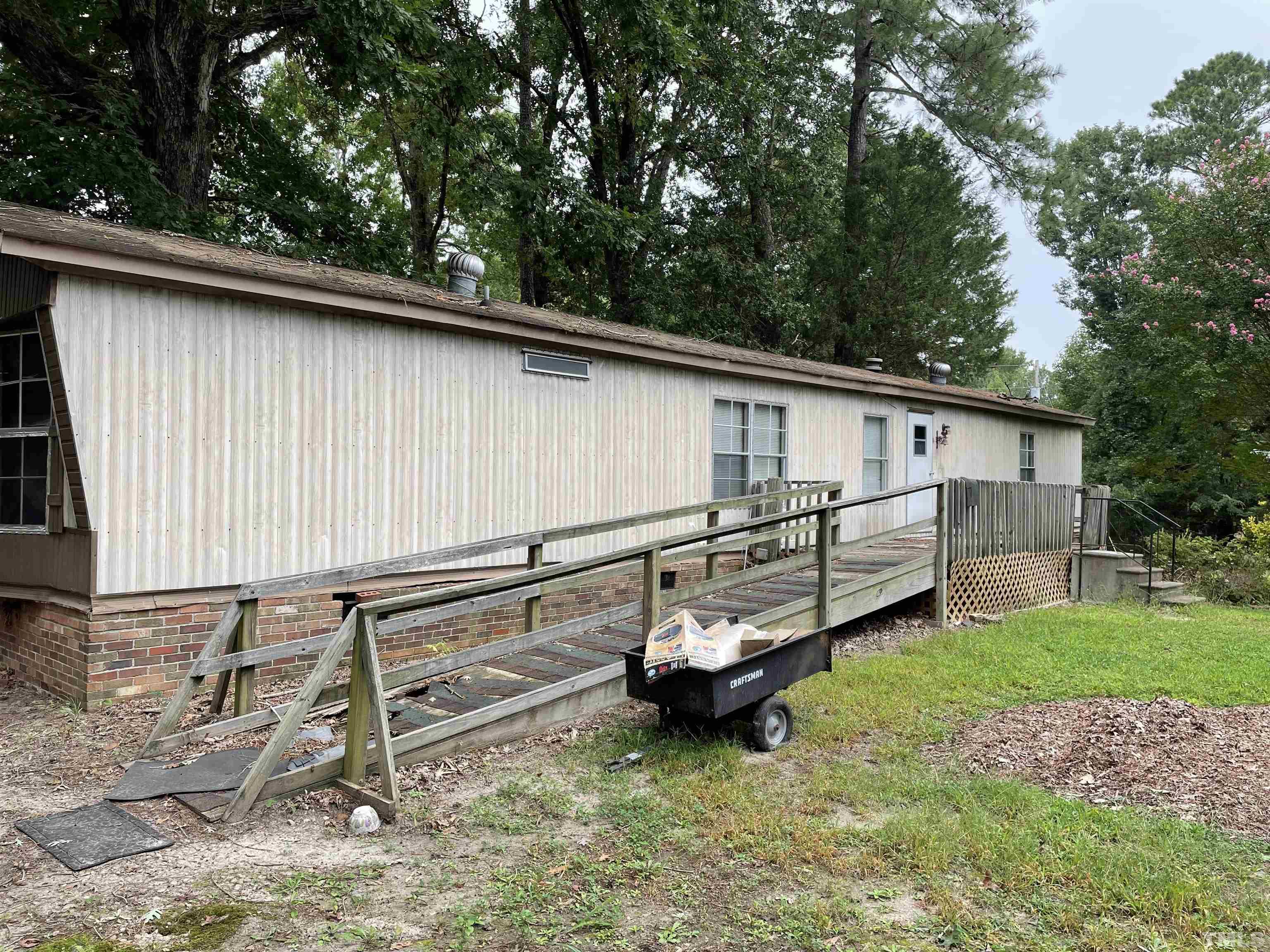 4029 Burlington Mills Road Wake Forest, NC 27587 - Photo 2 of 3 a backyard of a house with barbeque oven and outdoor seating