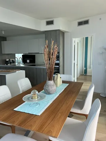 a dining room with furniture and wooden floor