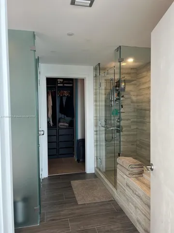 a bathroom with a shower and a sink