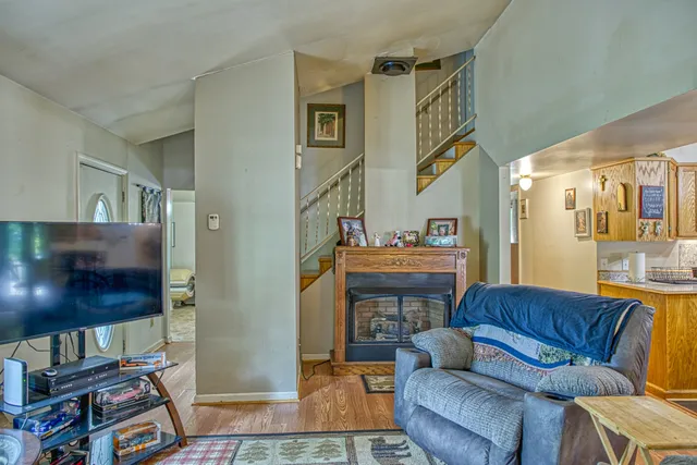 a living room with furniture a flat screen tv and a bookshelf