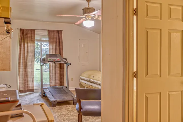a bathroom with a toilet and a glass shower door