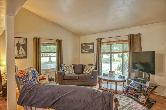 a bedroom with a bed and a flat screen tv