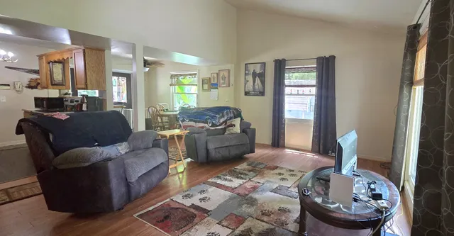 a living room with furniture and a mirror