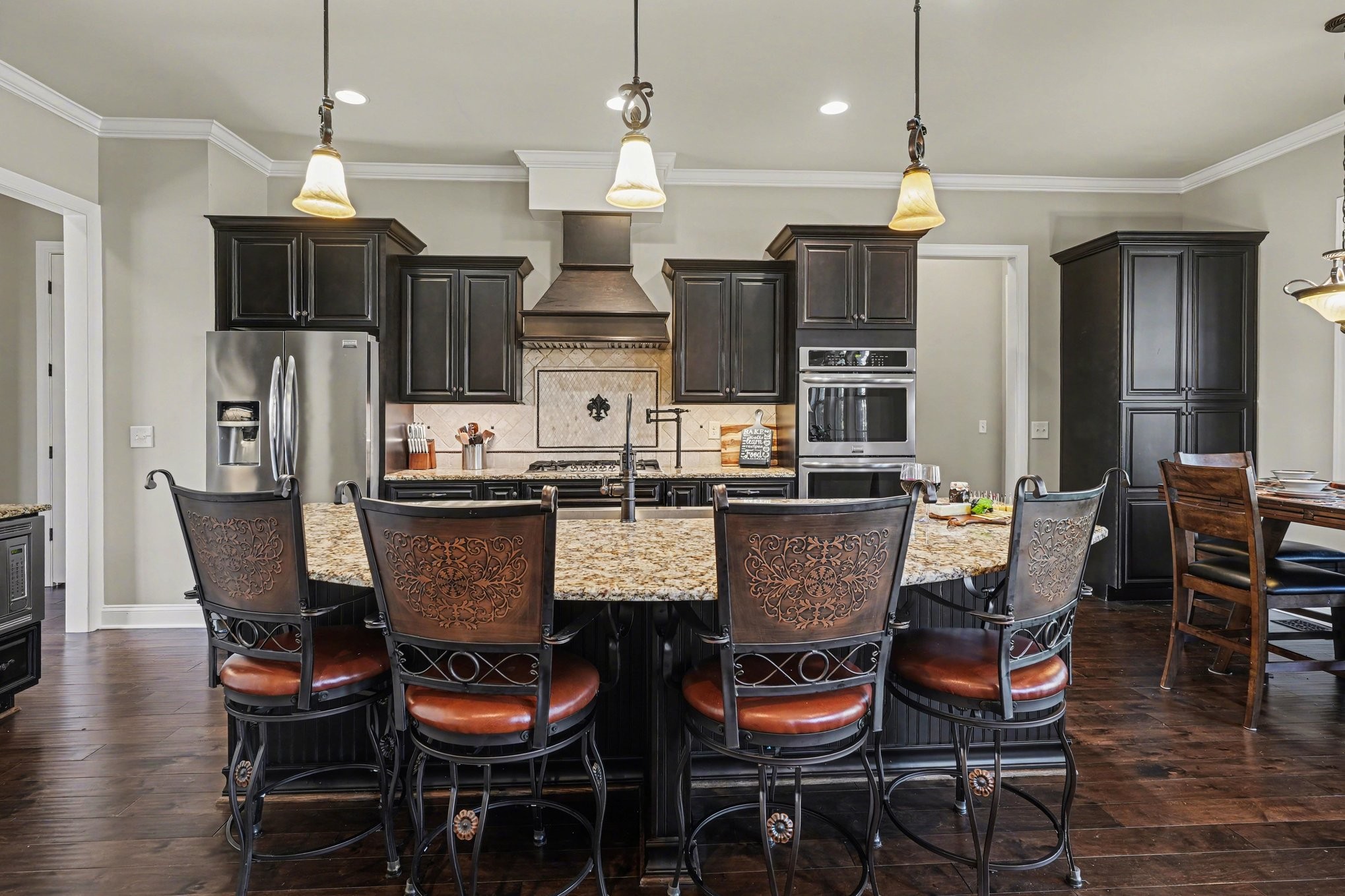 5094 Moss Road Nashville, TN 37221 - Photo 13 of 29 a kitchen with stainless steel appliances kitchen island granite countertop a dining table chairs and a refrigerator