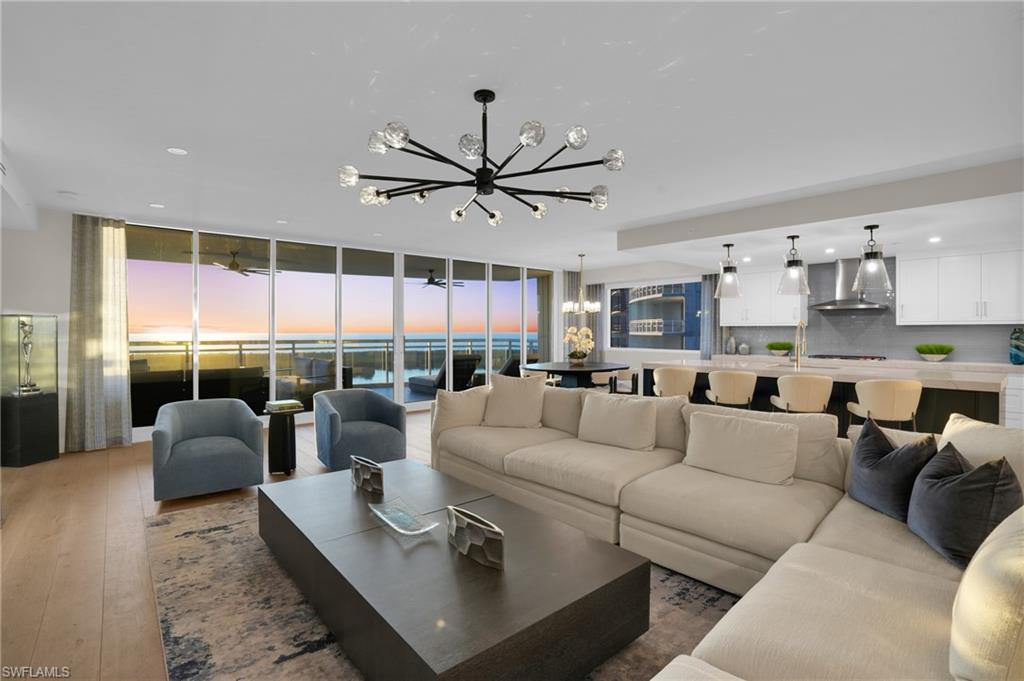 13945 Old Coast Road, Unit 1906 Naples, FL 34110 - Photo 25 of 40 a living room with furniture ceiling fan and a large window