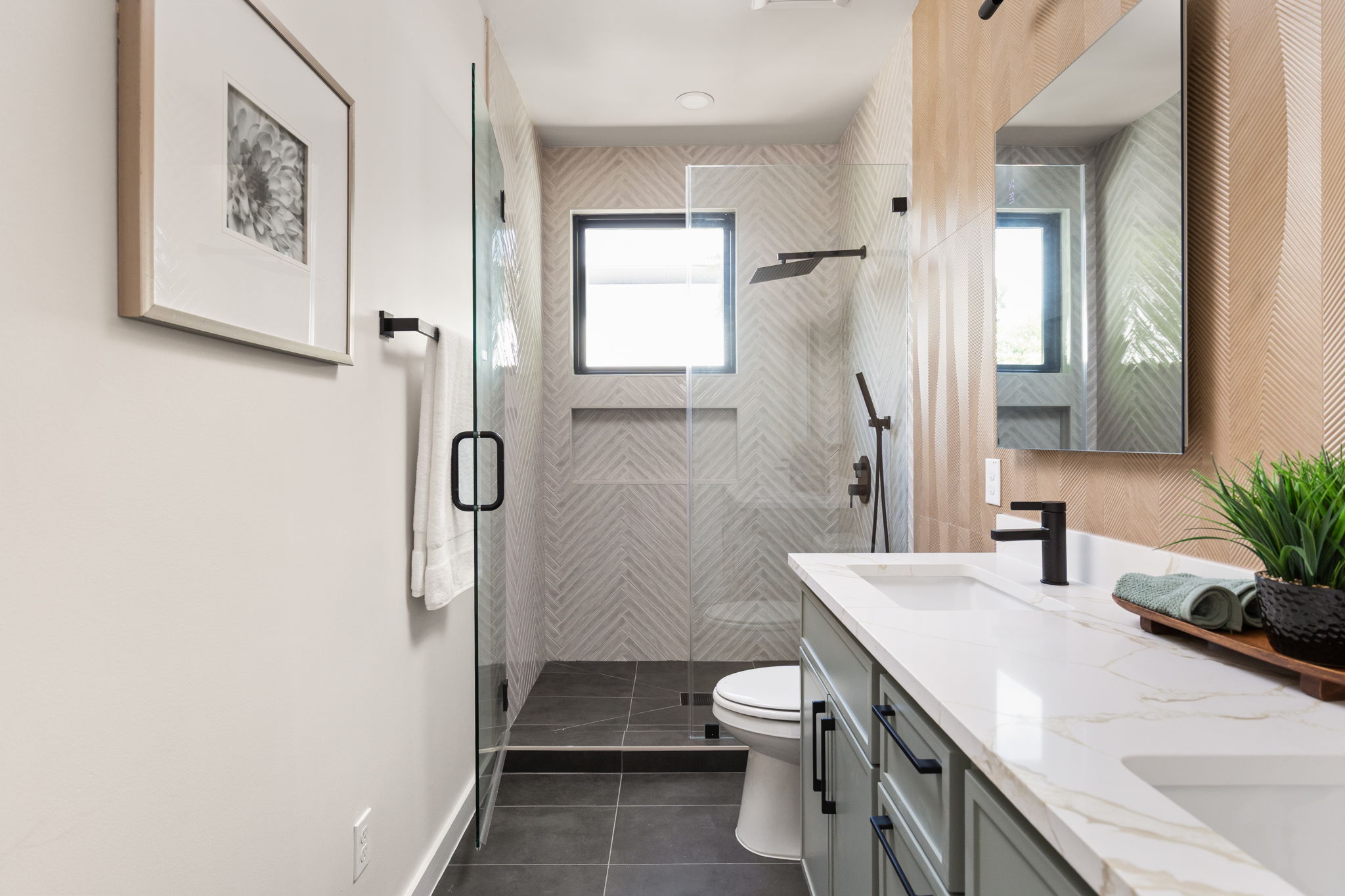 2717 Lyons Road, Unit 1 Austin, TX 78702 - Photo 21 of 40 A well-lit bathroom featuring a spacious walk-in shower with sleek glass doors and a modern double vanity.