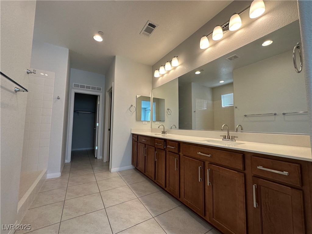 11585 Salt Creek Avenue Las Vegas, NV 89138 - Photo 15 of 45 Bathroom with a shower stall, double vanity, light tile patterned floors, a walk in closet, and recessed lighting