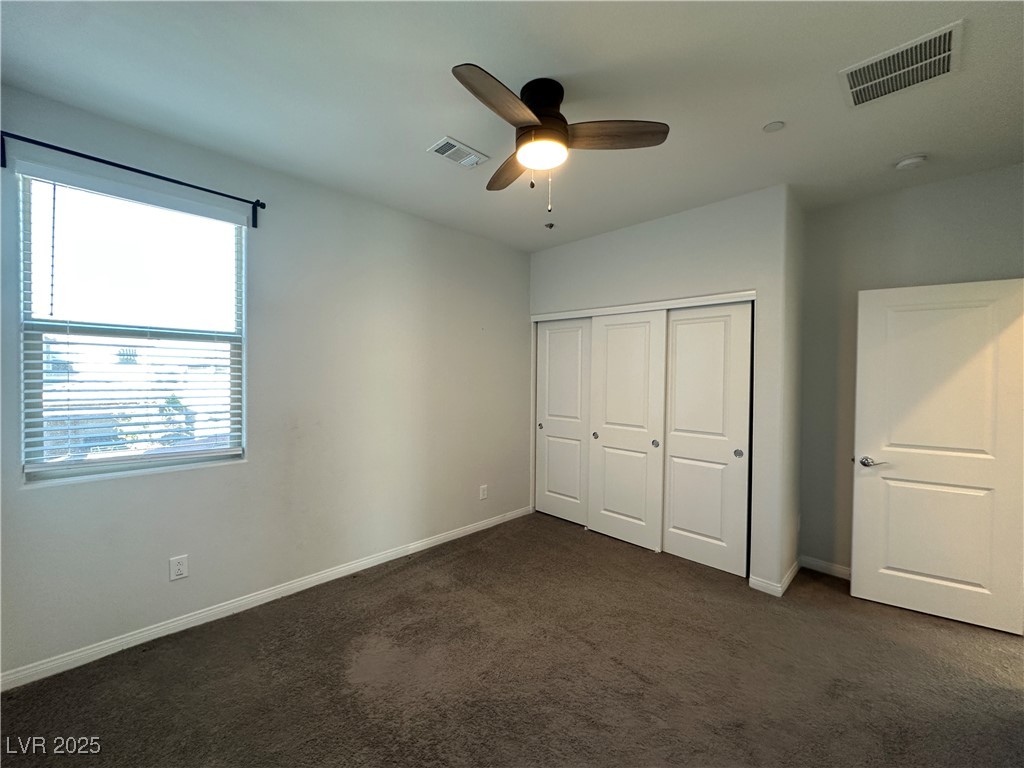 11585 Salt Creek Avenue Las Vegas, NV 89138 - Photo 27 of 45 Unfurnished bedroom featuring dark carpet, a closet, and ceiling fan