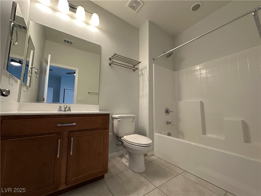 11585 Salt Creek Avenue Las Vegas, NV 89138 - Photo 28 of 45 Bathroom featuring vanity, light tile patterned flooring, bathtub / shower combination, and a textured wall