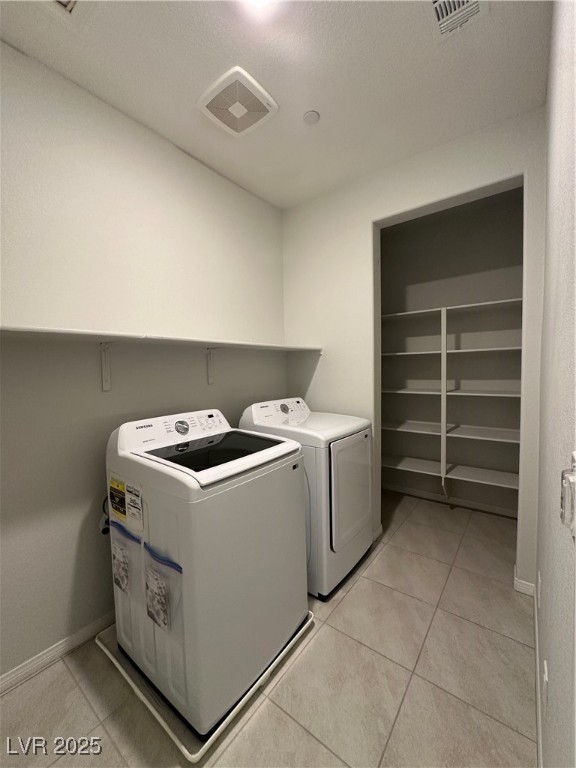 11585 Salt Creek Avenue Las Vegas, NV 89138 - Photo 33 of 45 Laundry room featuring light tile patterned floors and washing machine and dryer