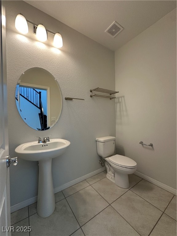 11585 Salt Creek Avenue Las Vegas, NV 89138 - Photo 7 of 45 Half bath with light tile patterned floors and a textured wall