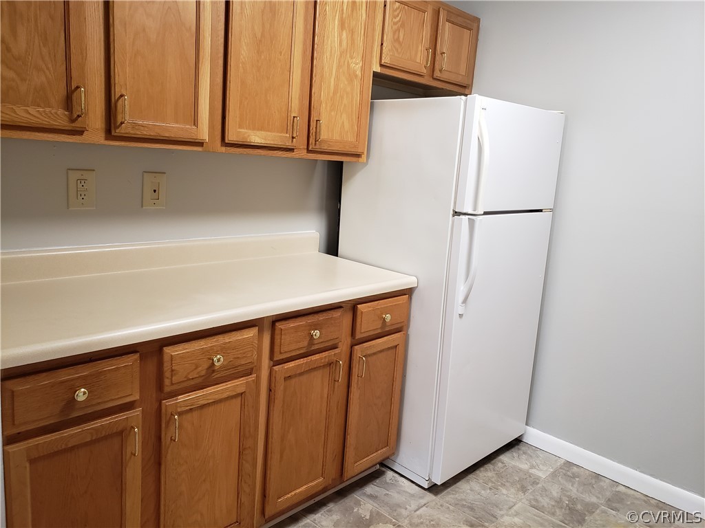 5612 Crenshaw Road, Unit 1113 Richmond, VA 23227 - Photo 19 of 19 a kitchen with cabinets and a refrigerator