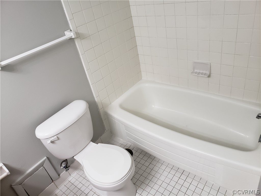 5612 Crenshaw Road, Unit 1113 Richmond, VA 23227 - Photo 6 of 19 a white toilet sitting next to a bath tub