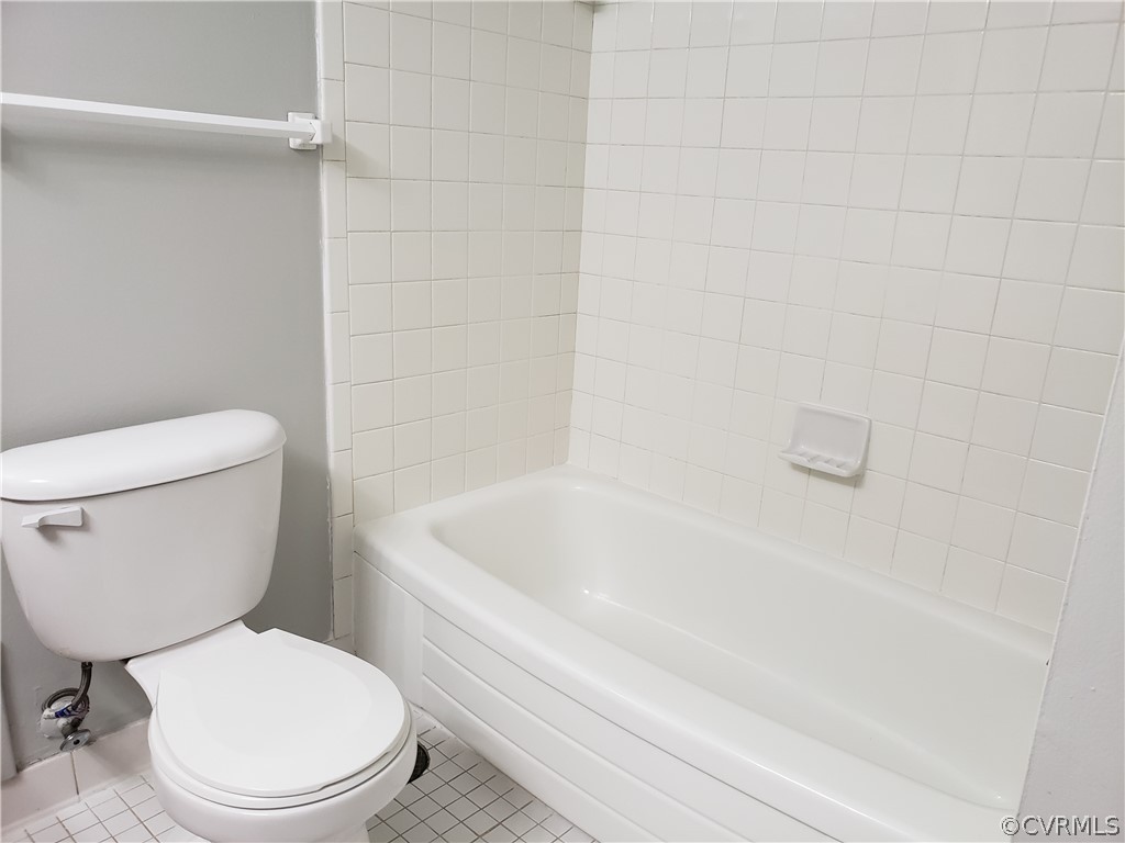 5612 Crenshaw Road, Unit 1113 Richmond, VA 23227 - Photo 7 of 19 a white toilet and tub sitting next to a bathroom sink