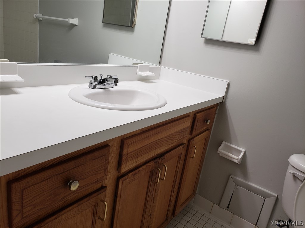 5612 Crenshaw Road, Unit 1113 Richmond, VA 23227 - Photo 8 of 19 a bathroom with a sink and a mirror