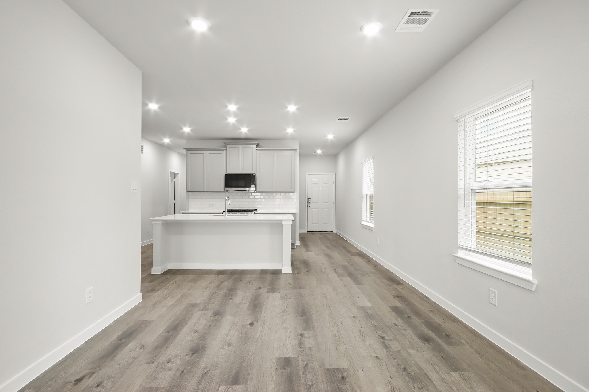 225 Spring Drive Hockley, TX 77447 - Photo 8 of 24 a view of kitchen with kitchen island a sink wooden floor and a stove