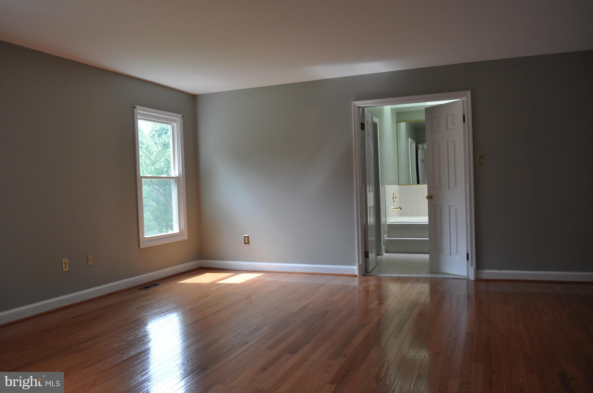 14616 Falling Leaf Way Gaithersburg, MD 20878 - Photo 11 of 23 a view of an empty room with wooden floor and a window
