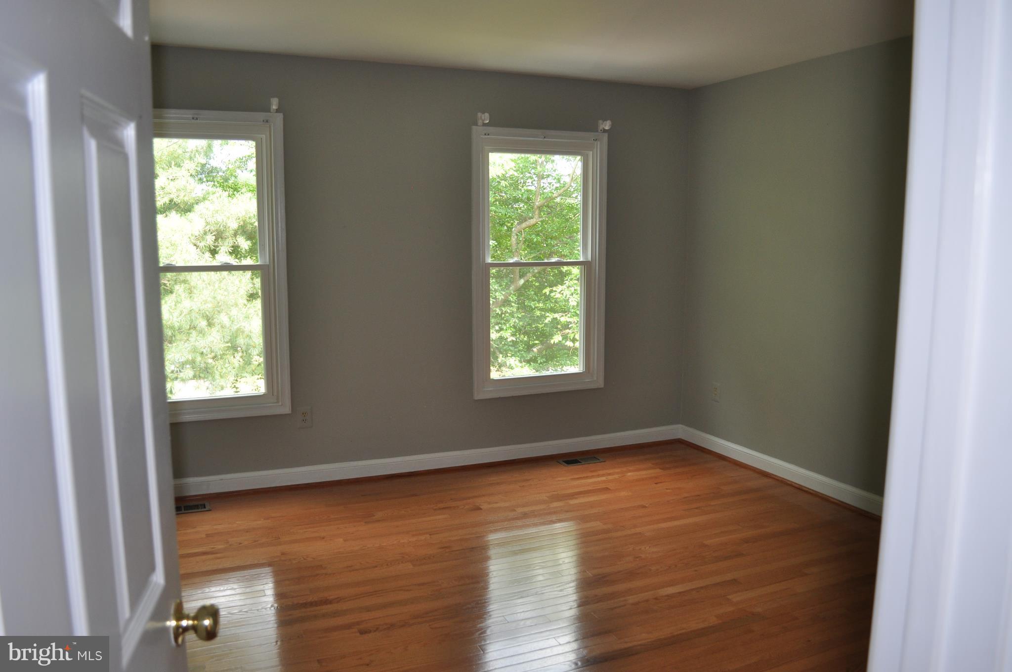 14616 Falling Leaf Way Gaithersburg, MD 20878 - Photo 14 of 23 an empty room with wooden floor and windows