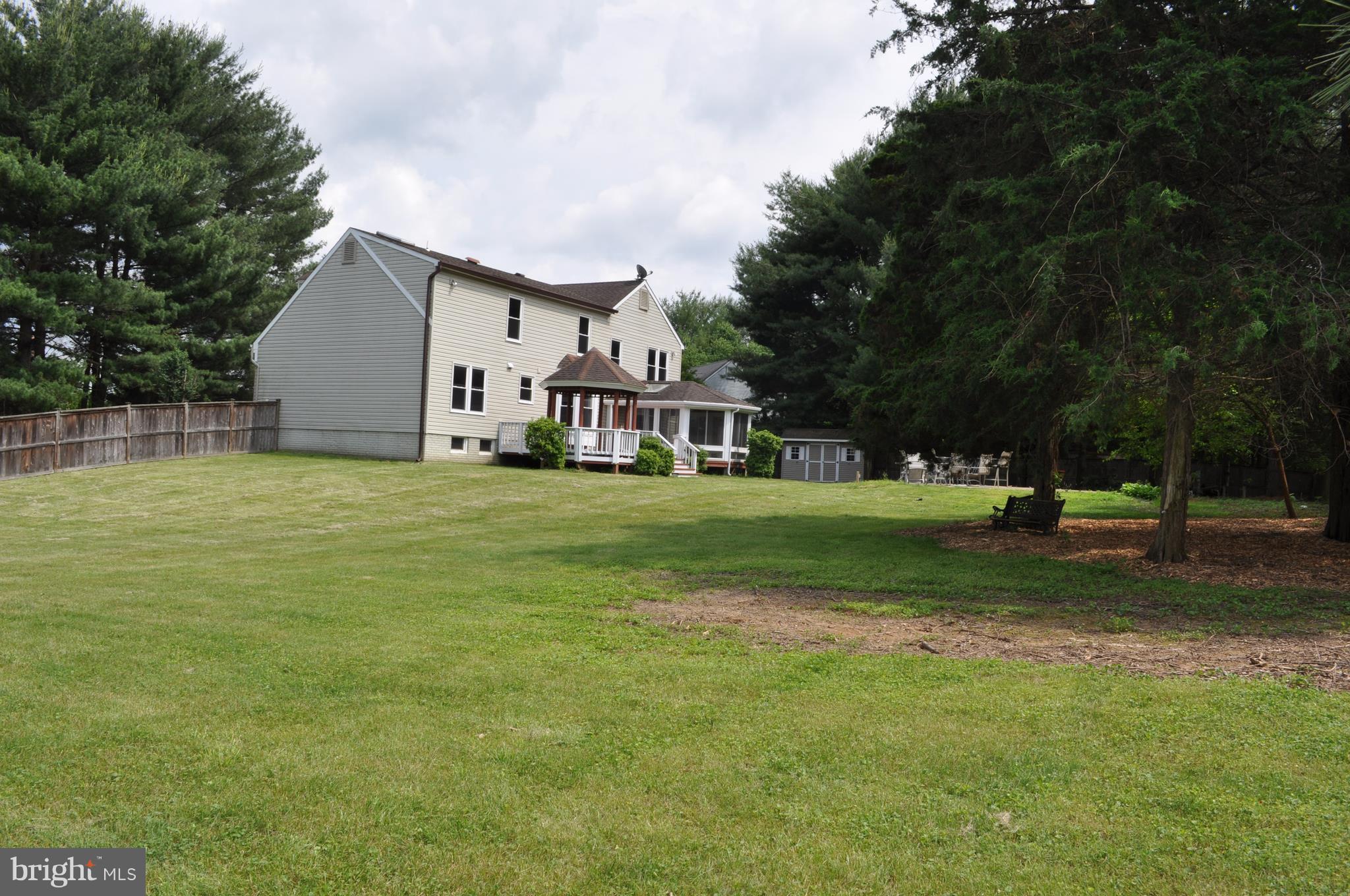 14616 Falling Leaf Way Gaithersburg, MD 20878 - Photo 21 of 23 a view of a house with a big yard and large trees
