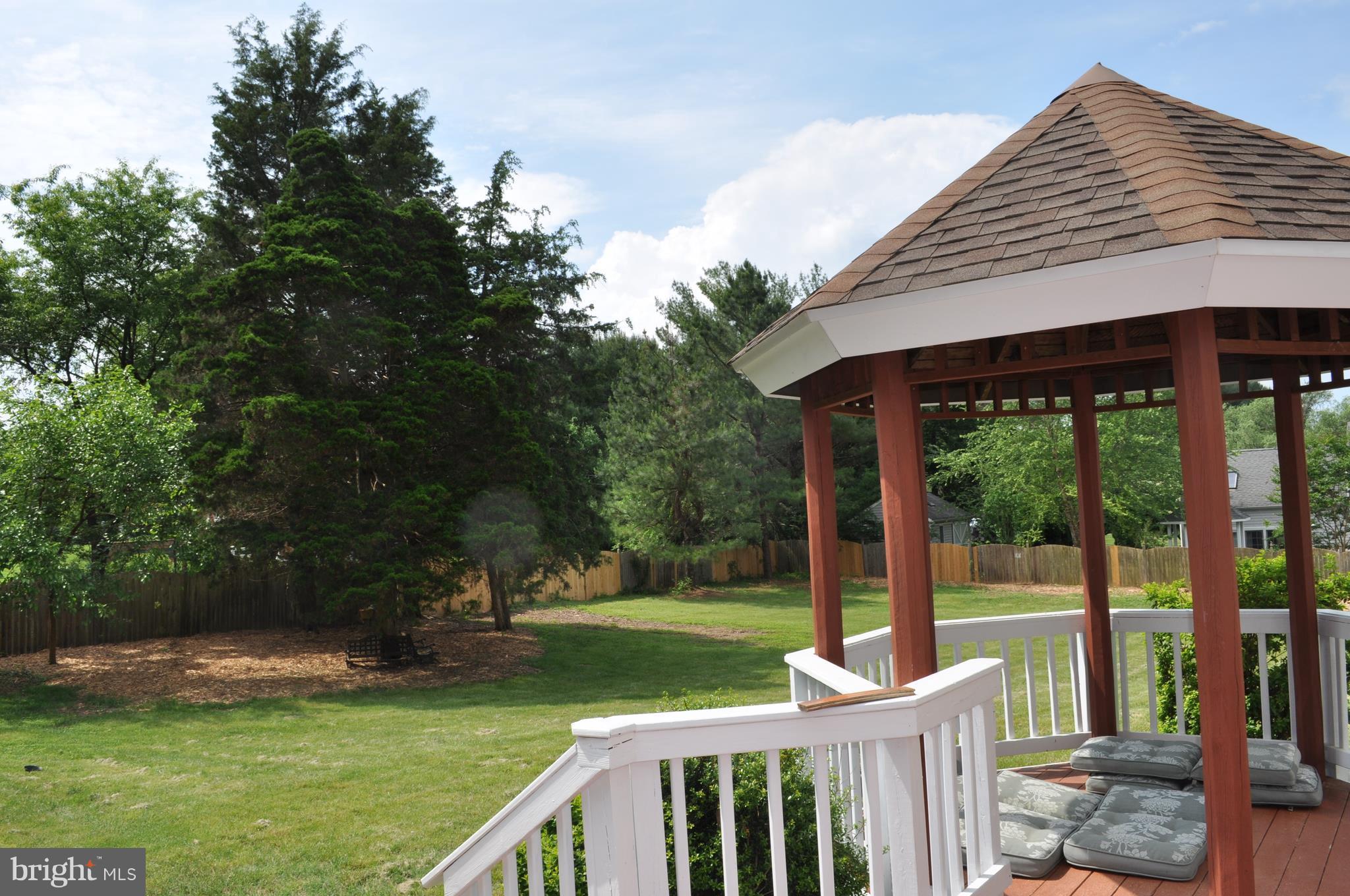 14616 Falling Leaf Way Gaithersburg, MD 20878 - Photo 22 of 23 a view of a deck with a table and chairs under an umbrella