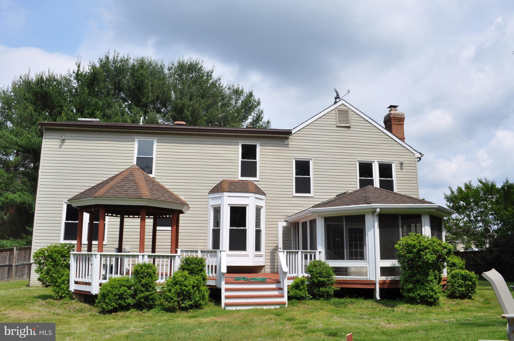 14616 Falling Leaf Way Gaithersburg, MD 20878 - Photo 3 of 23 a front view of a house with a yard