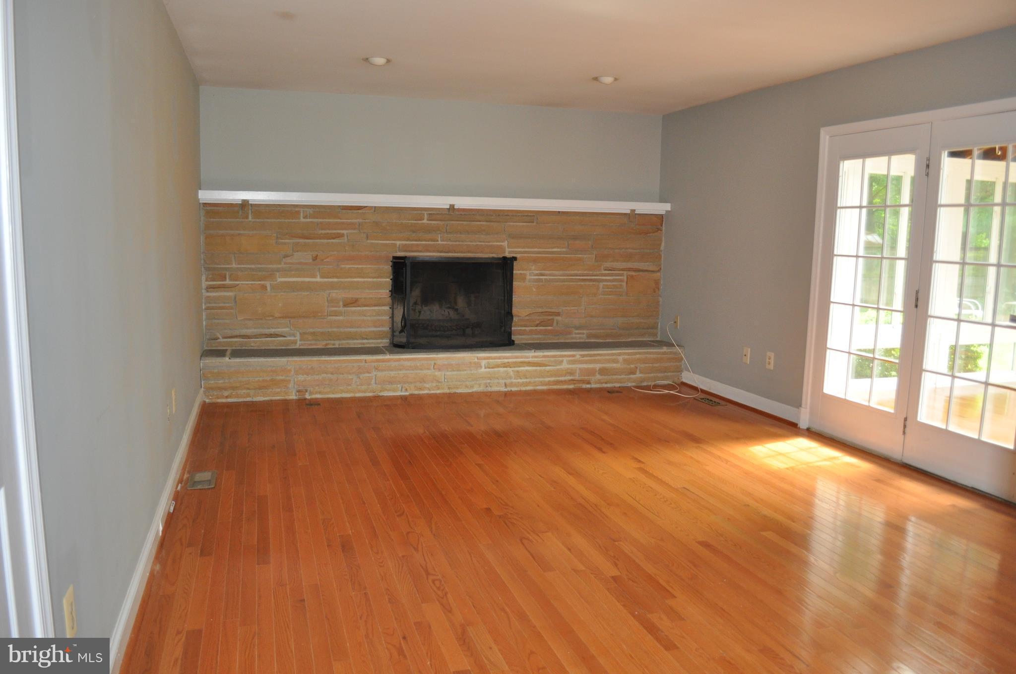 14616 Falling Leaf Way Gaithersburg, MD 20878 - Photo 6 of 23 a view of empty room with wooden floor and fireplace