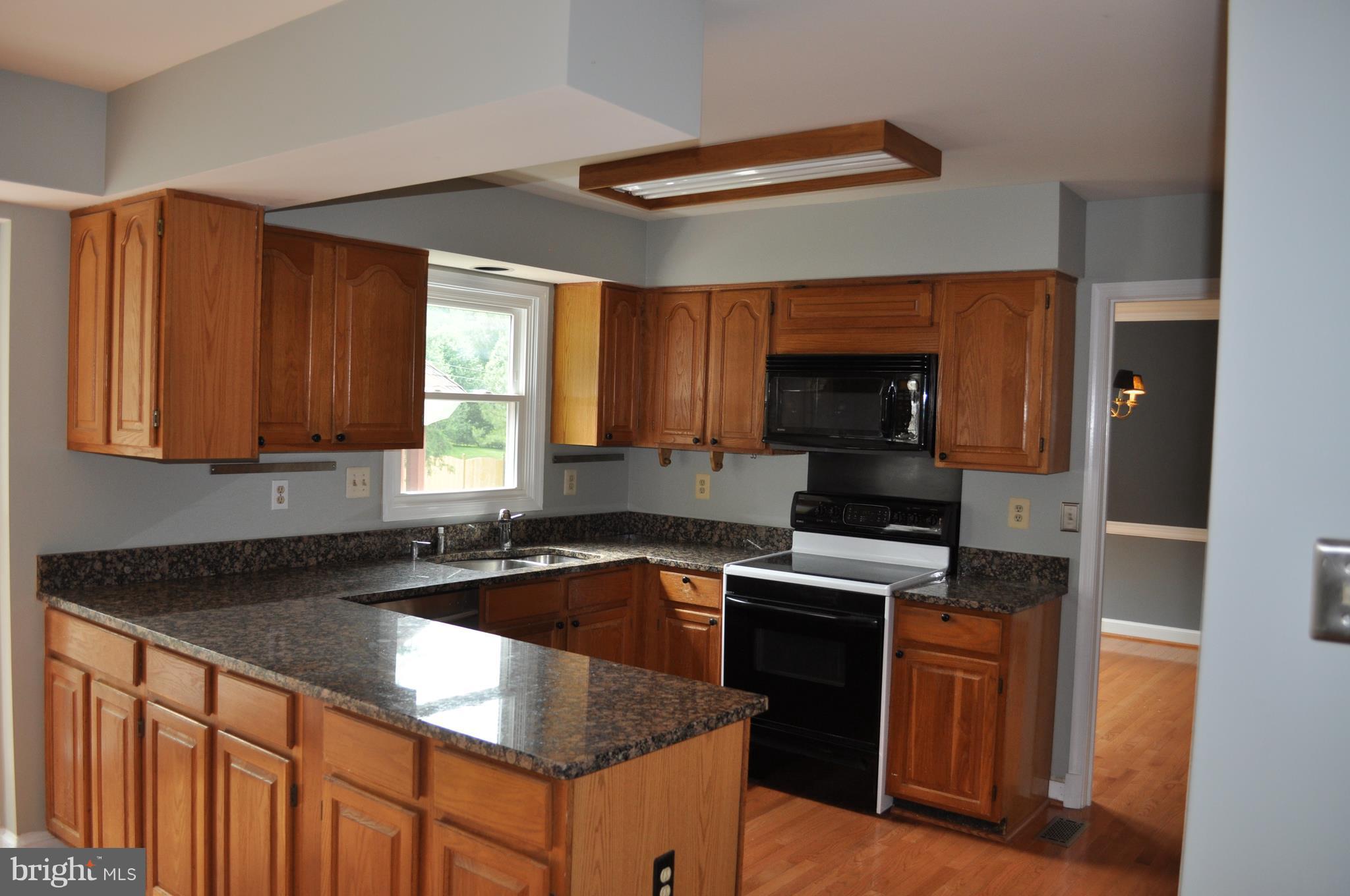 14616 Falling Leaf Way Gaithersburg, MD 20878 - Photo 8 of 23 a kitchen that has a sink and a stove in it