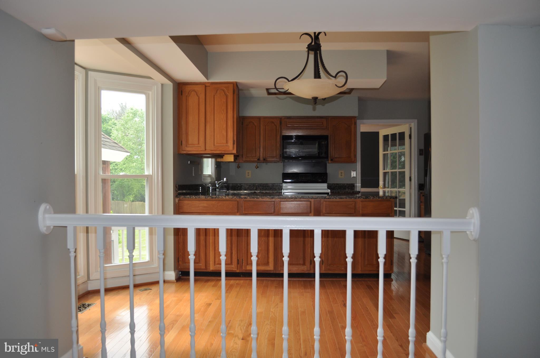 14616 Falling Leaf Way Gaithersburg, MD 20878 - Photo 9 of 23 a kitchen with stainless steel appliances a stove and a window