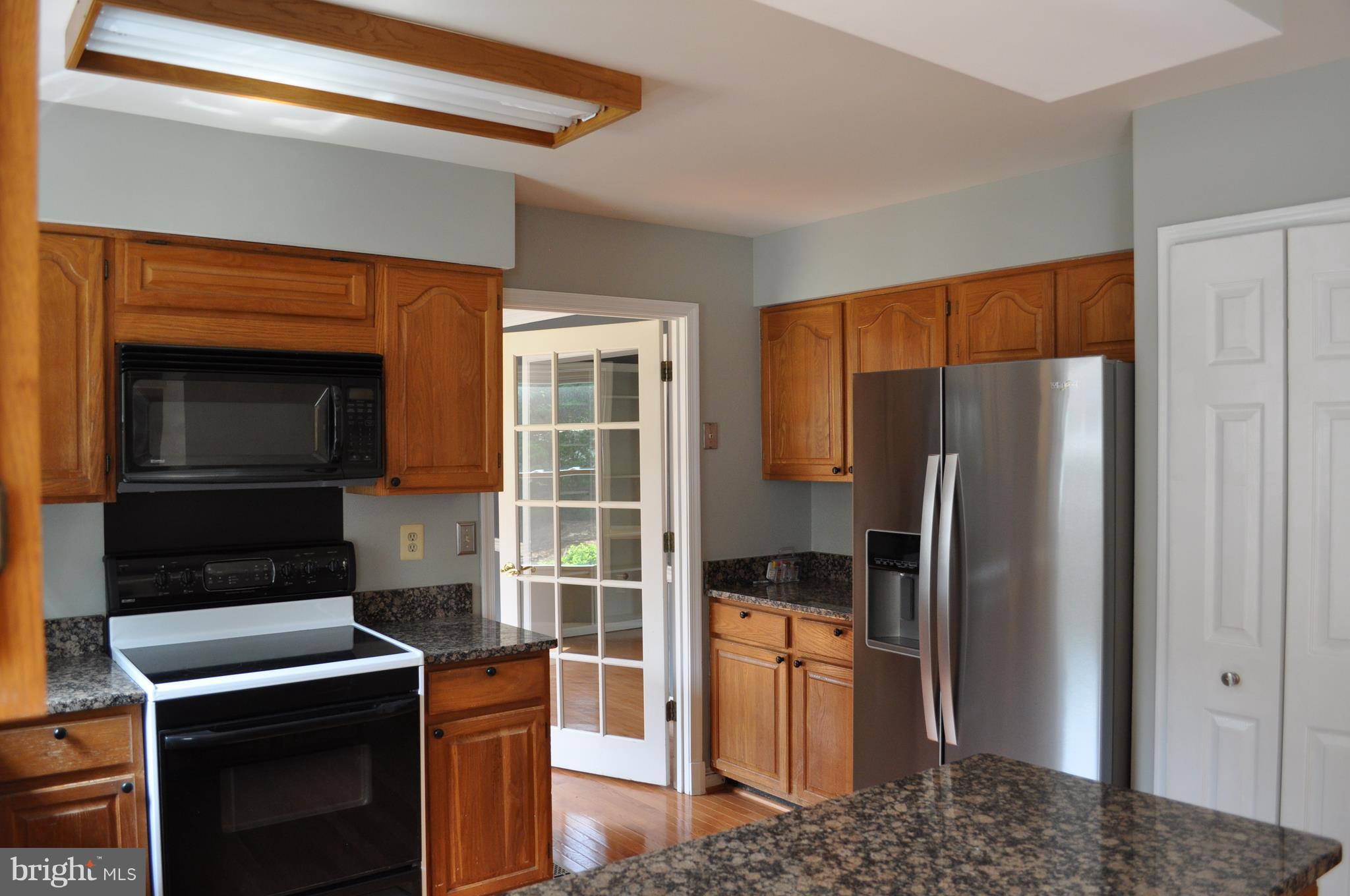 14616 Falling Leaf Way Gaithersburg, MD 20878 - Photo 10 of 23 a kitchen with stainless steel appliances granite countertop a refrigerator a stove and a sink