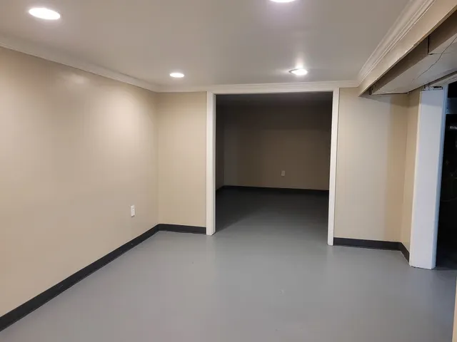 a room with a window and furniture