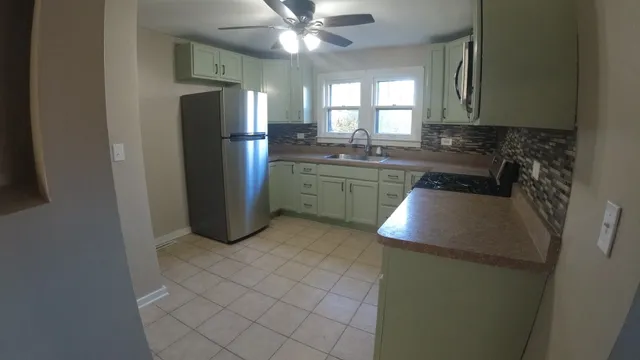 a kitchen with a refrigerator and a sink