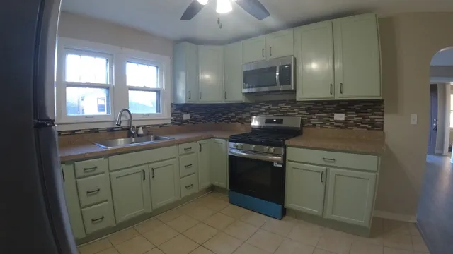 a kitchen with a sink stove and cabinets