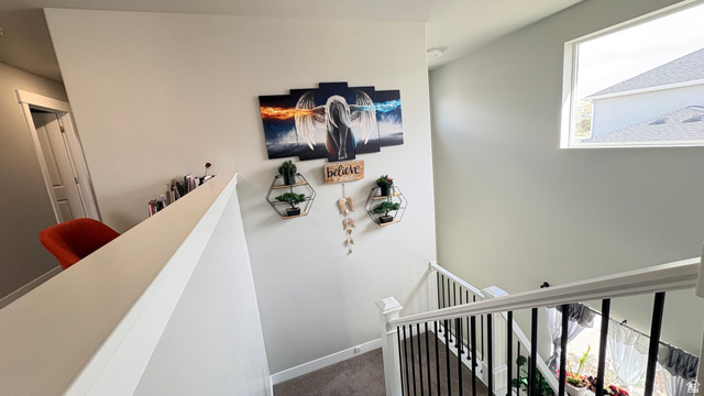 7889 Bristlecone Road Eagle Mountain, UT 84005 - Photo 20 of 42 Staircase with white newel posts and black iron balusters