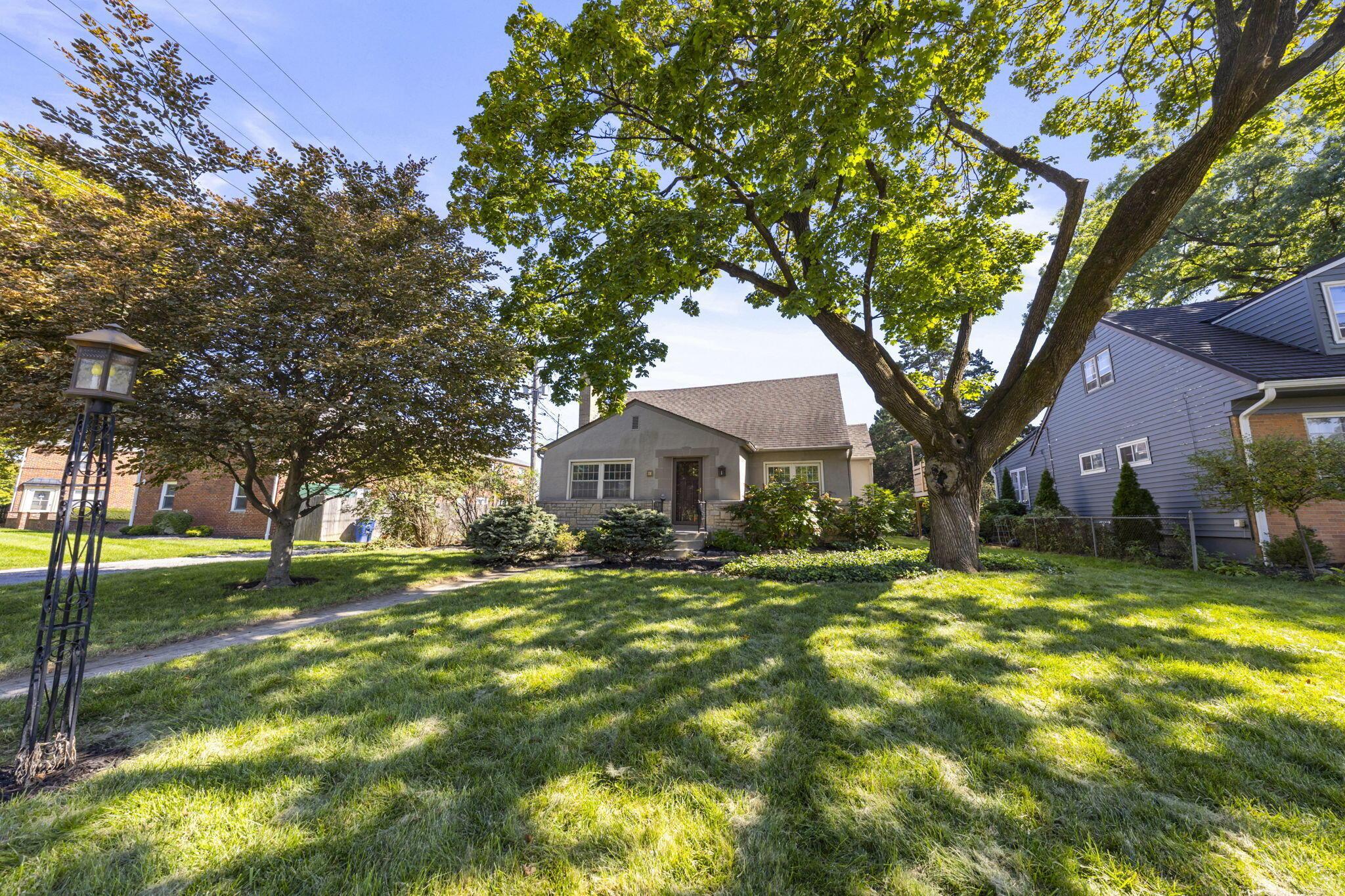 40 South Kellner Road Columbus, OH 43209 - Photo 55 of 57 Front exterior featuring a gabled roofline, stone facade elements, and mature trees providing natural shade